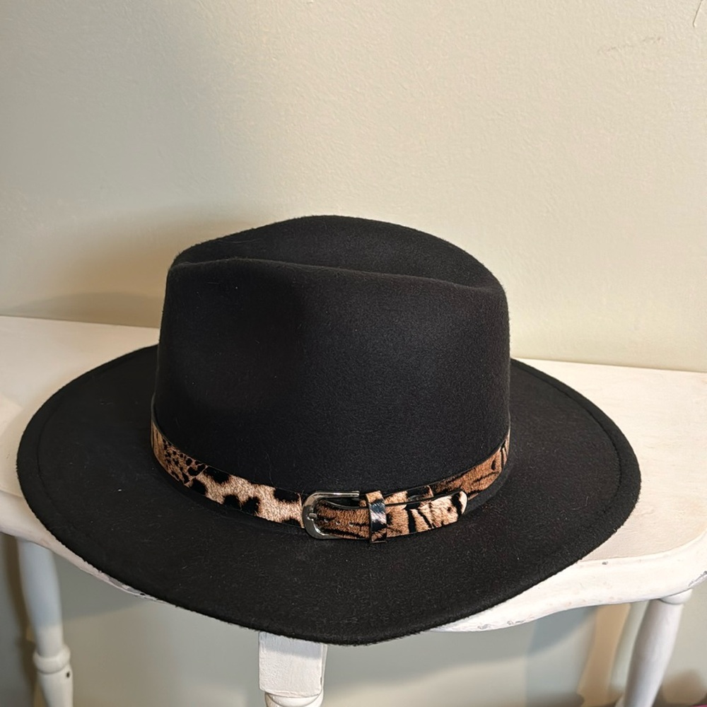 Black fedora hat with adjustable string and cheetah print strap around hat